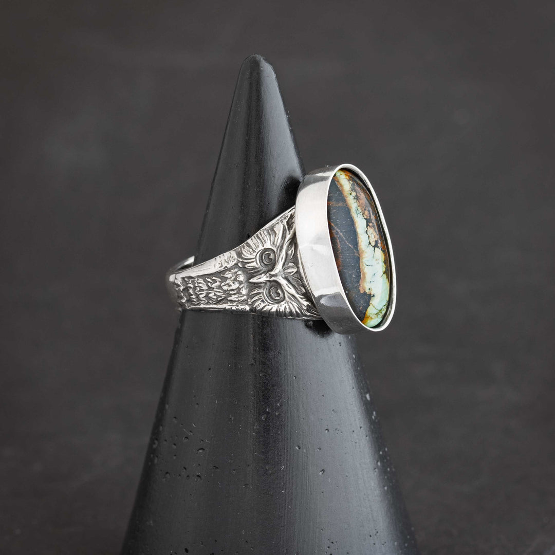 Close-up detail of sterling silver owl design with intricate blackened texture on handcrafted ring. Artisan crafted heirloom ring in Fort Collins, Colorado.