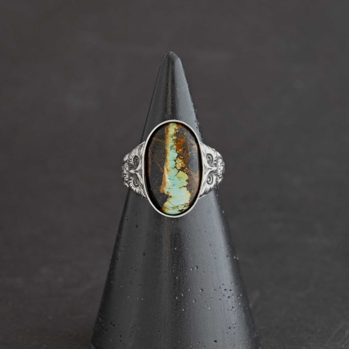 Natural blackjack turquoise cabochon set in fine silver bezel on handcrafted owl ring. Handmade in Fort Collins, Colorado.