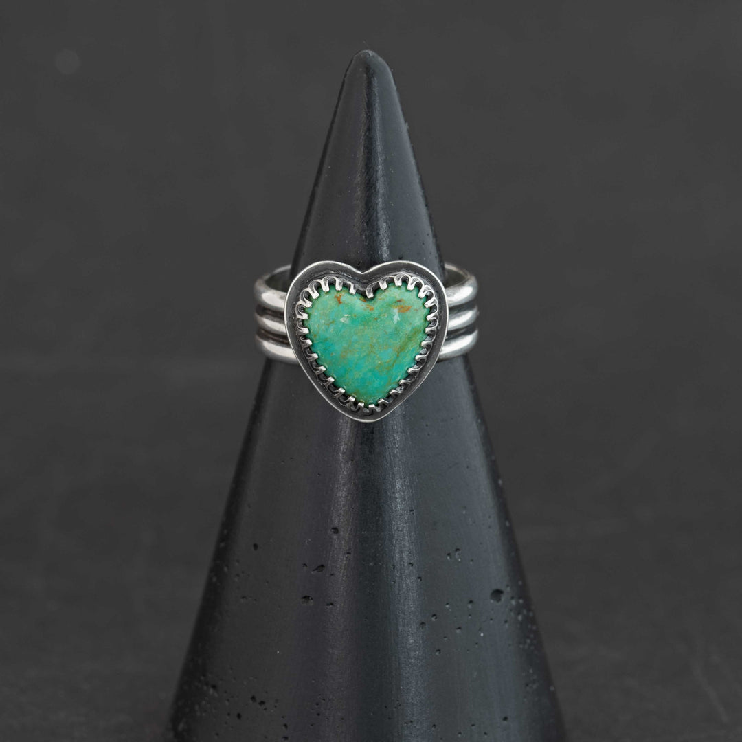 Blue-green Sonora turquoise heart ring with rust matrix flecks in serrated sterling silver bezel, size 7