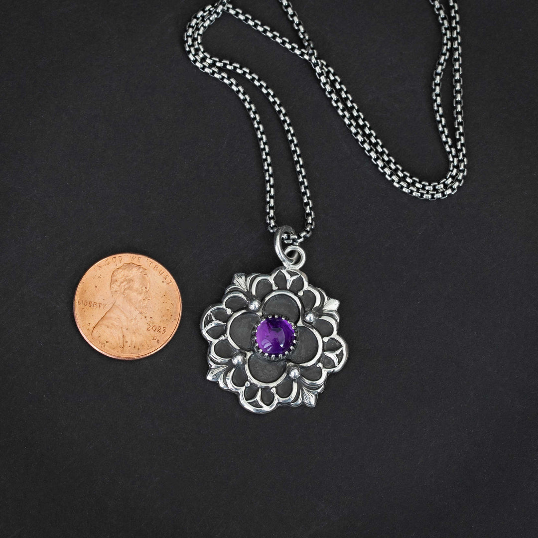 Vintage-inspired silver pendant with French Gothic design and purple gemstone