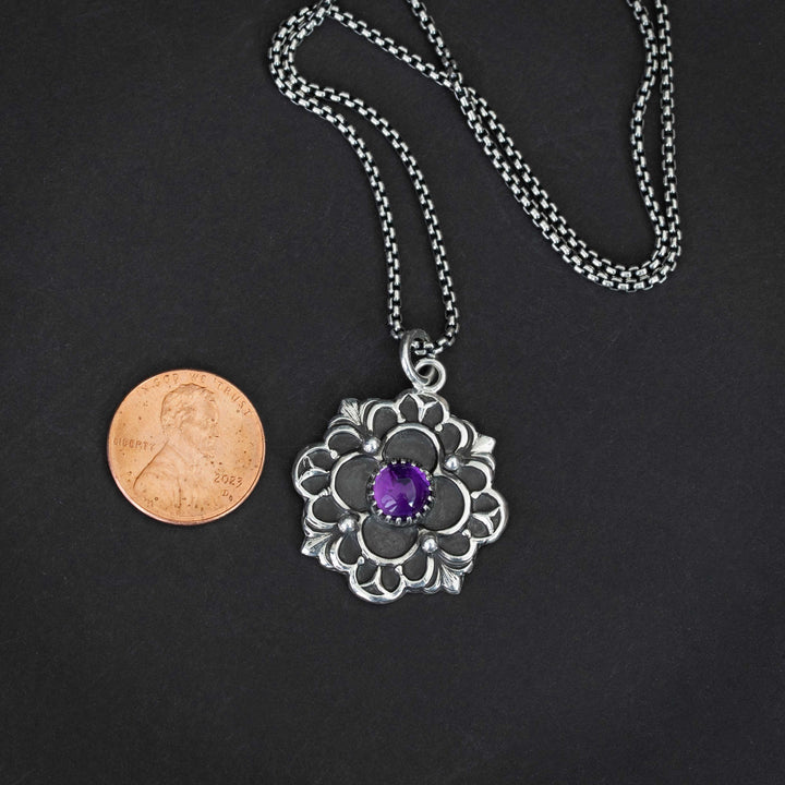 Vintage-inspired silver pendant with French Gothic design and purple gemstone