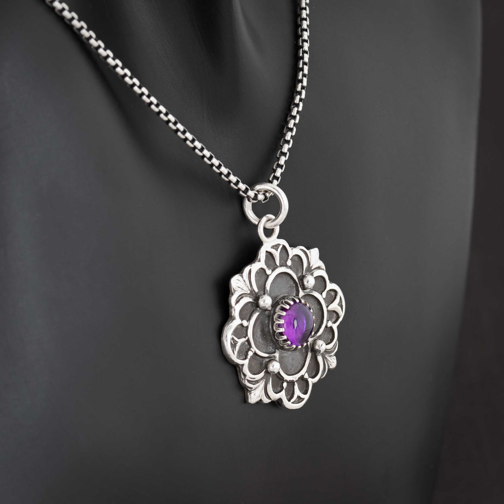 Gothic quatrefoil silver pendant featuring 7mm amethyst cabochon and ornate detailing