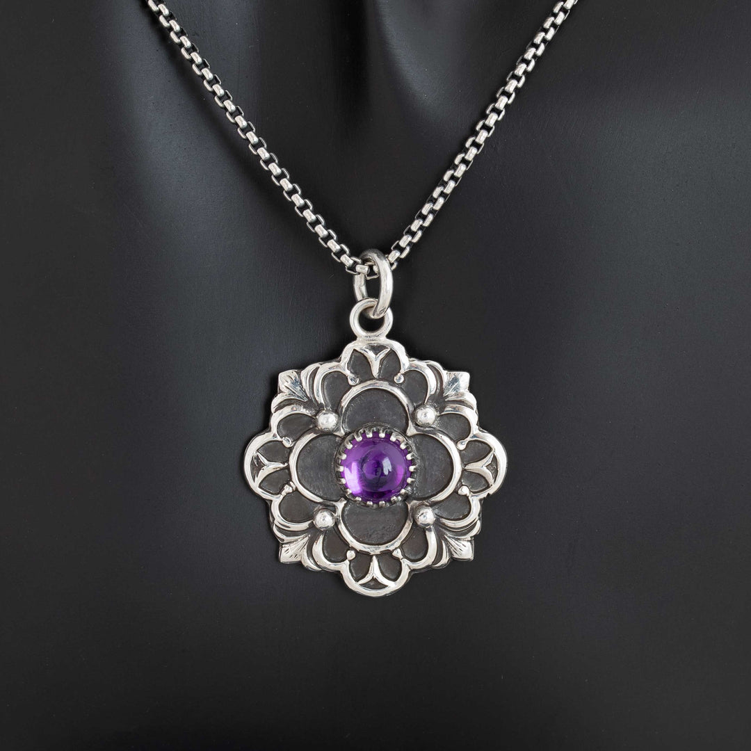 Handcrafted sterling silver gothic flower pendant with vibrant purple amethyst cabochon