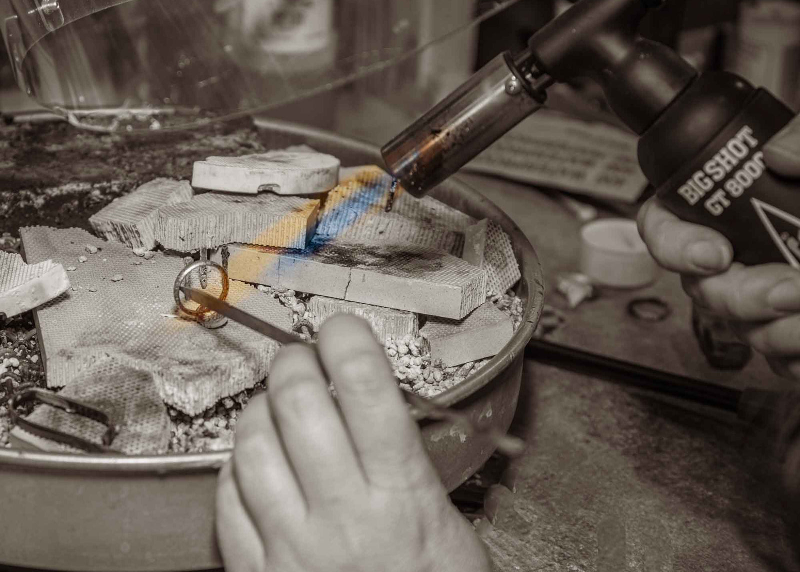 Silversmith crafting handmade jewelry using traditional torch soldering technique in Colorado studio, highlighting the meticulous artisan process behind Silverthaw's handcrafted turquoise jewelry