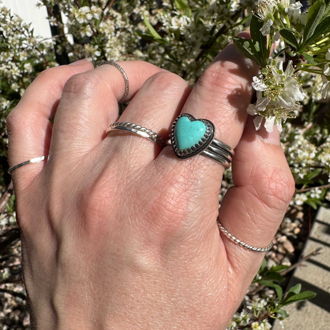 Detailed view of robin's egg blue Sonora turquoise heart cabochon with handcrafted silver bezel, size 10