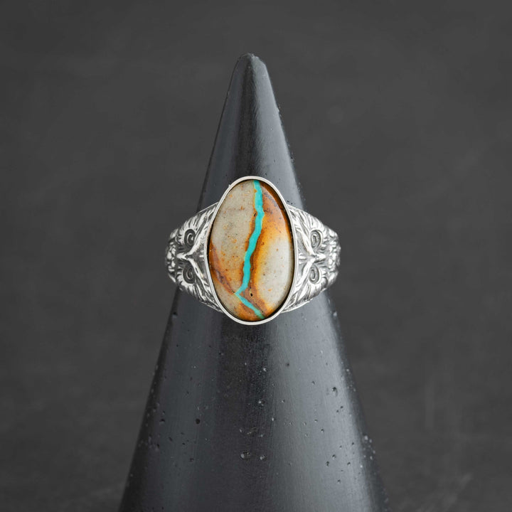 Handcrafted sterling silver owl ring with blue ribbon Royston turquoise cabochon. Made in Fort Collins, Colorado.