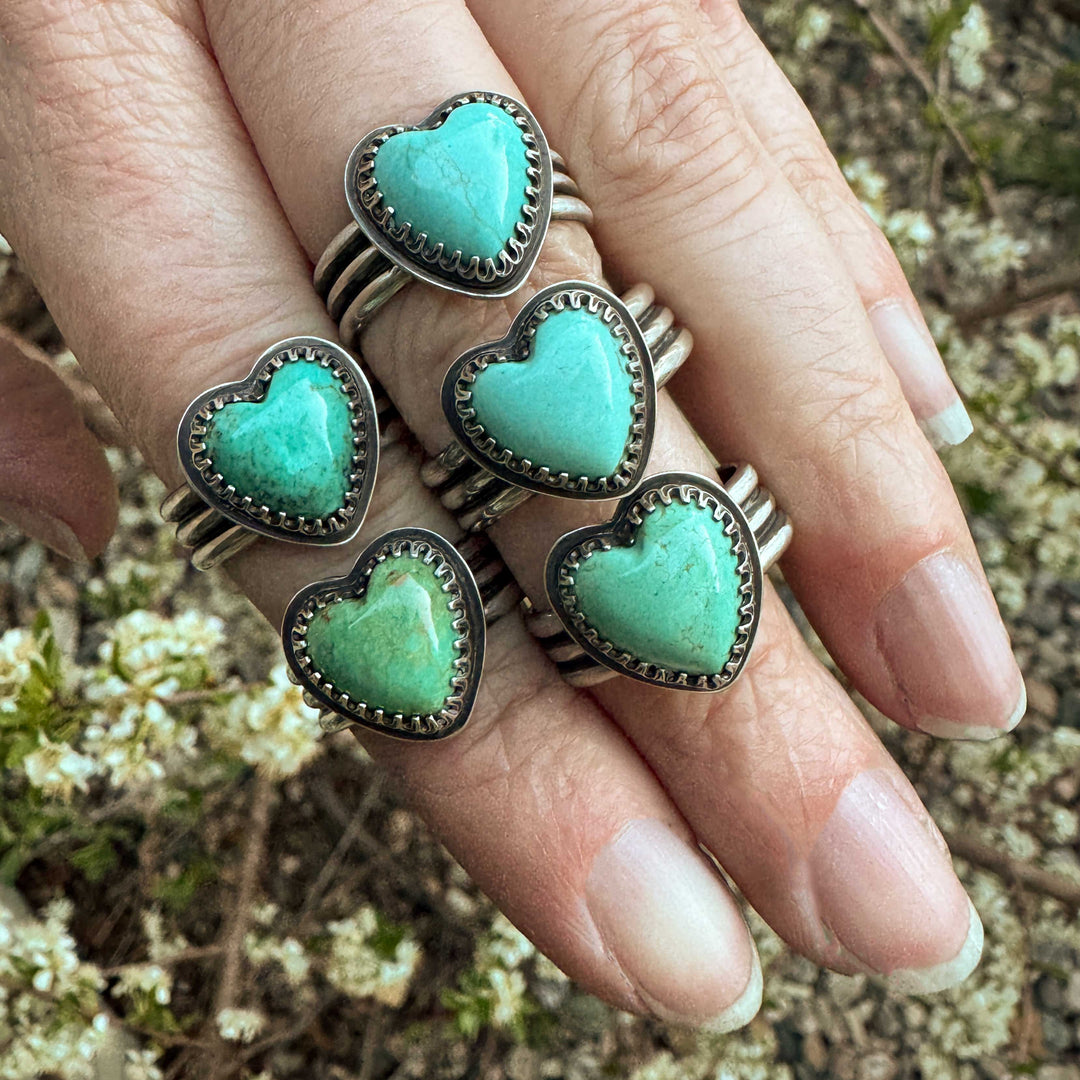 Close-up of blue heart-shaped Sonora turquoise rings in artisan triple-band silver ring, size 9.5