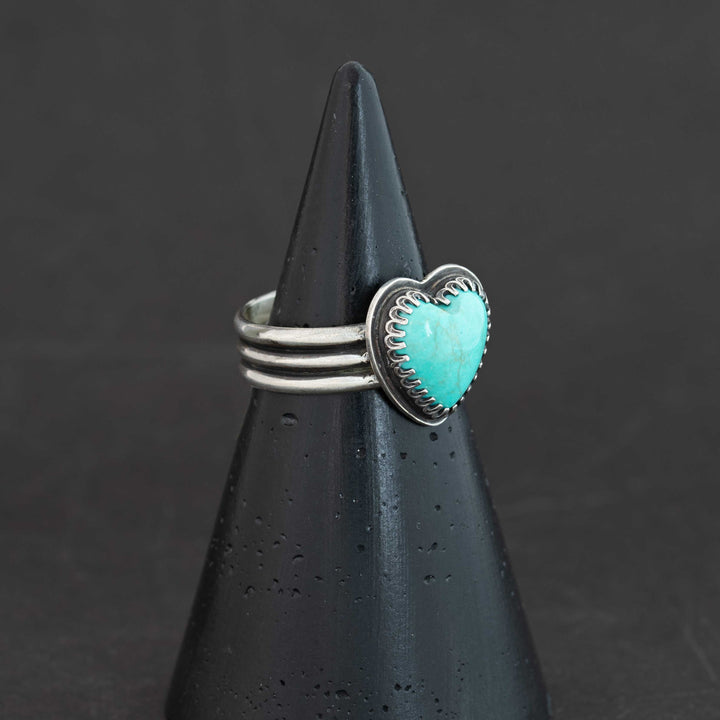 Sterling silver ring featuring luminous robin's egg blue Sonora turquoise heart, shown at angle, size 8.5