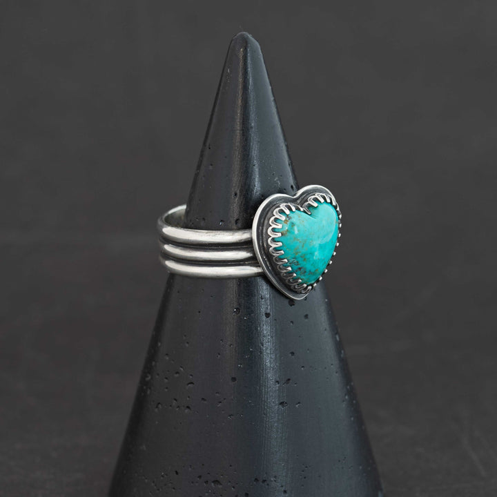 Sterling silver ring featuring dramatic deep ocean blue Sonora turquoise heart, shown at angle, size 9.5