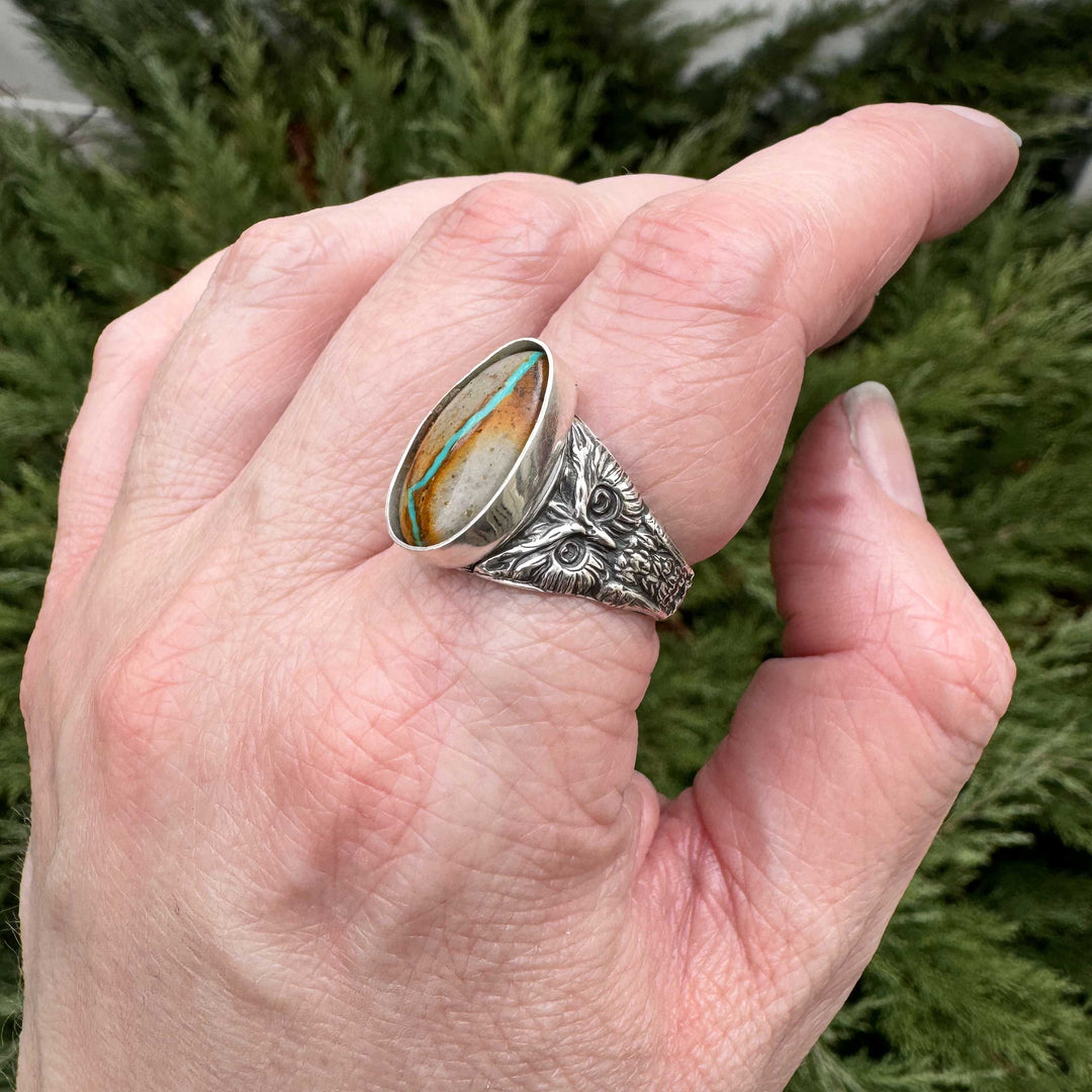 Side view of handcrafted owl ring showing detailed features and Royston Ribbon turquoise setting