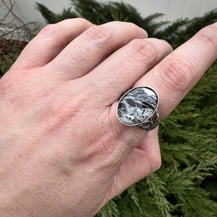 Handcrafted White Buffalo stone and sterling silver owl ring shown on hand