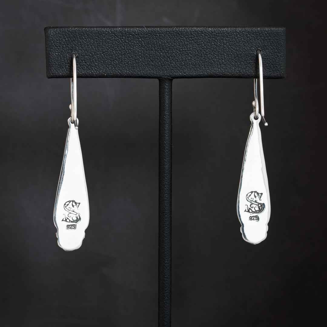 Back view of Black Jack turquoise earrings in sterling silver showing 925 hallmark and maker’s mark stamp, highlighting handcrafted artisan quality.