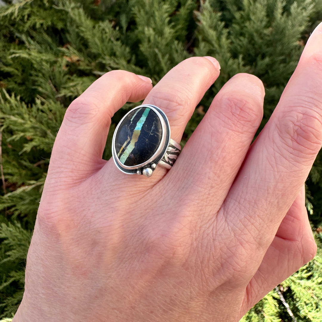 Rare Blackjack turquoise ring worn on hand outdoors, teal and gold ribbon matrix, artisan silver jewelry