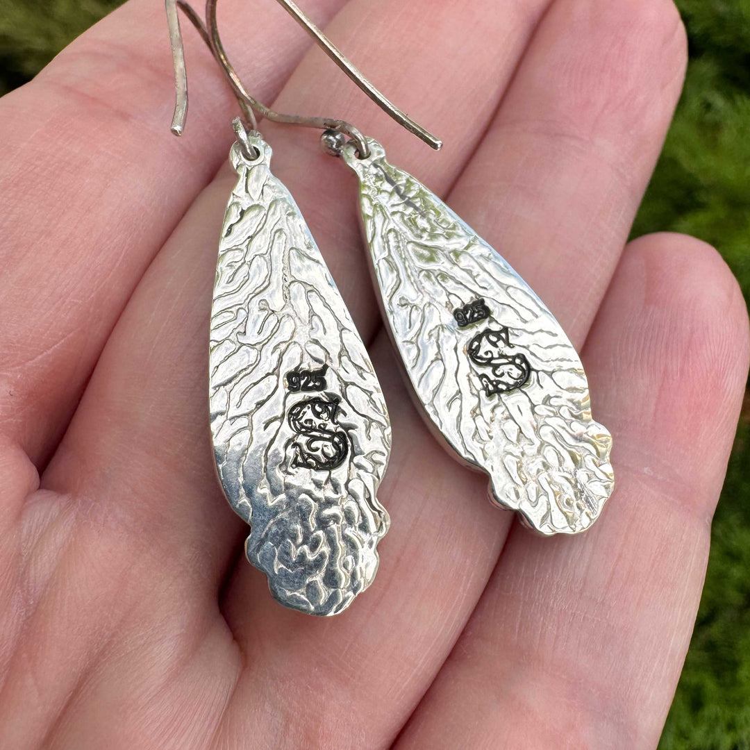 Back of Blackjack turquoise sterling silver earrings showing texture and maker's mark stamp with 925 hallmark, artisan silversmith