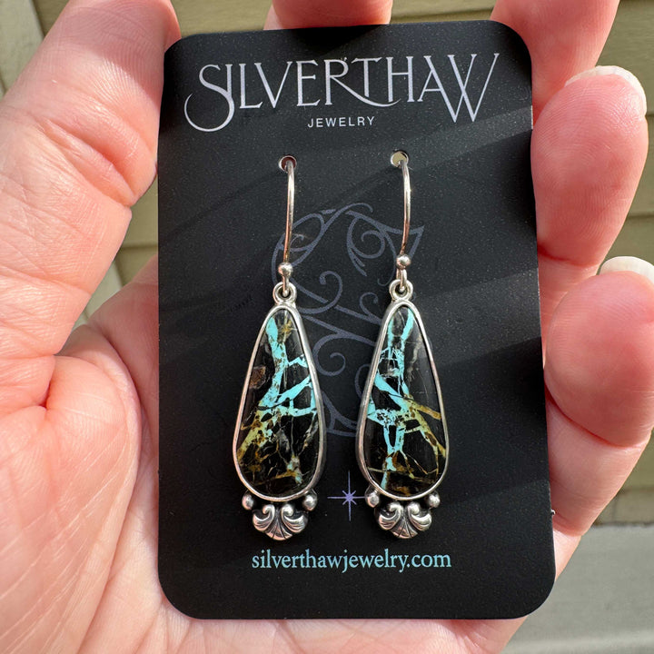 Blackjack turquoise teardrop drop earrings on Silverthaw Jewelry earring card, sterling silver with scroll detail, vivid teal matrix in dark chert