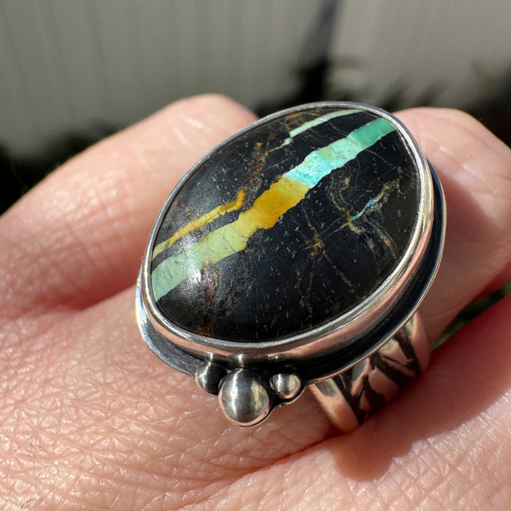 Natural Blackjack turquoise ring close-up showing vivid teal blue and gold veining in black chert matrix