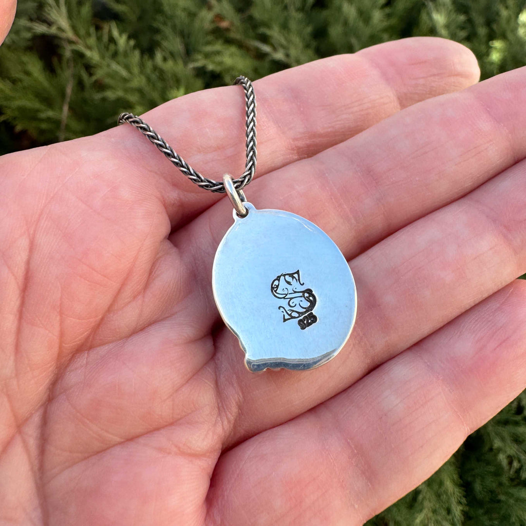 Back of Blackjack turquoise sterling silver pendant showing polished backplate with maker's mark stamp and .925 hallmark