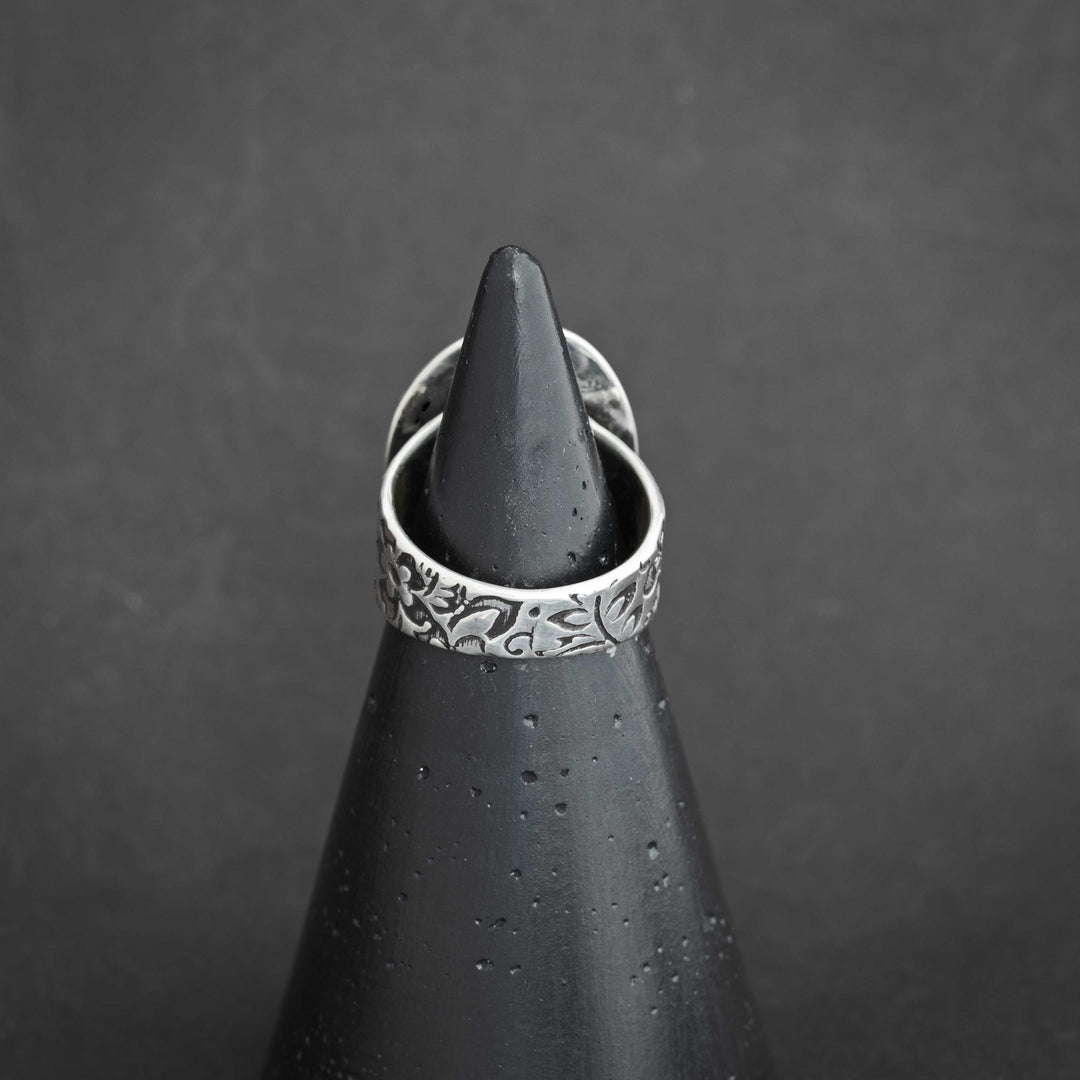 Back view of Blackjack turquoise ring with detailed floral pattern on the wide sterling silver band.