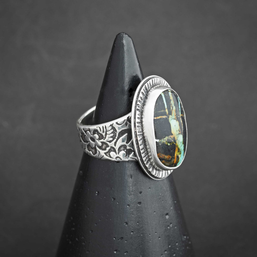 Side view of Blackjack turquoise ring showing ornate floral-engraved sterling silver band.