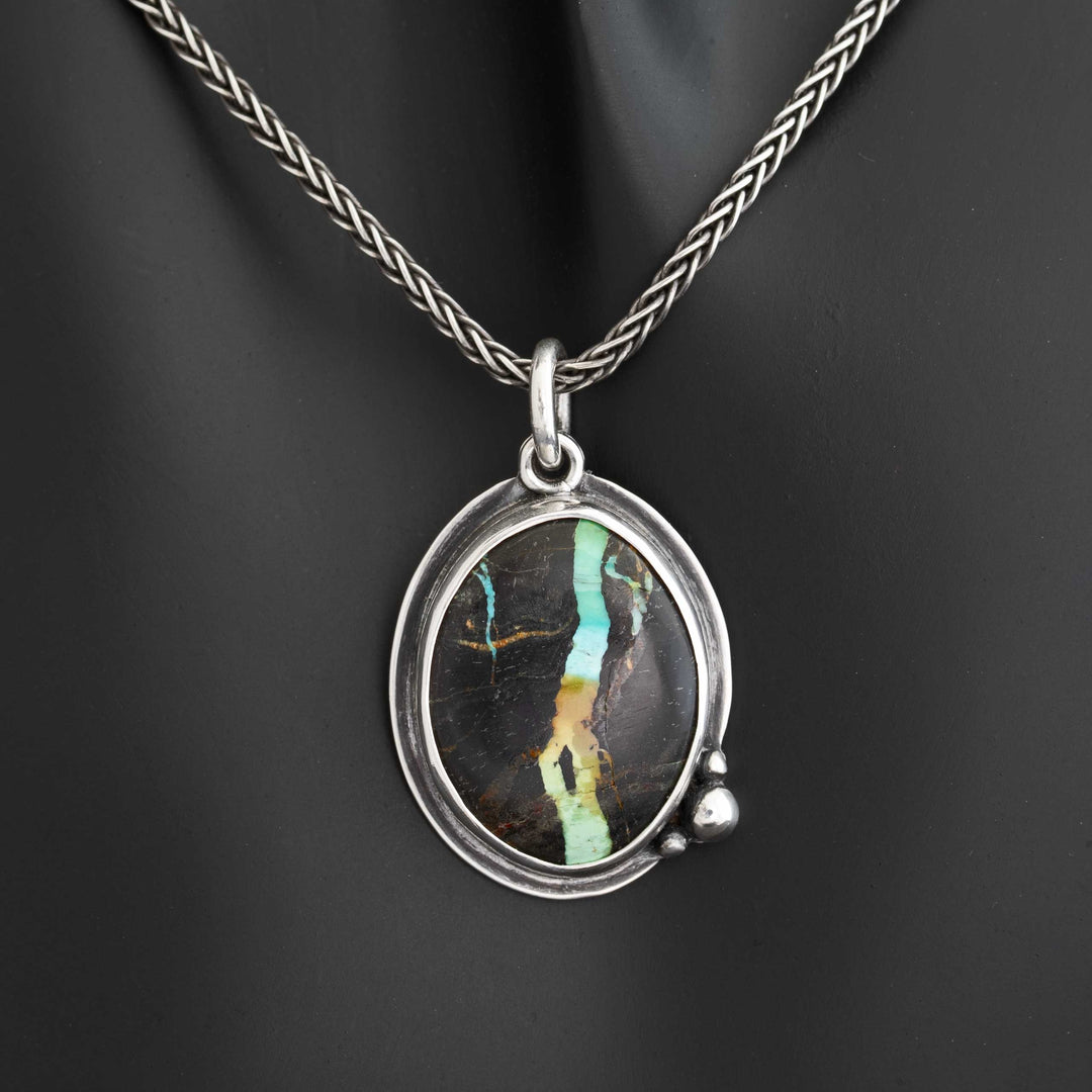 Blackjack turquoise statement necklace on dark display bust, sterling silver wheat chain, vivid ribbon matrix stone, handcrafted in Colorado