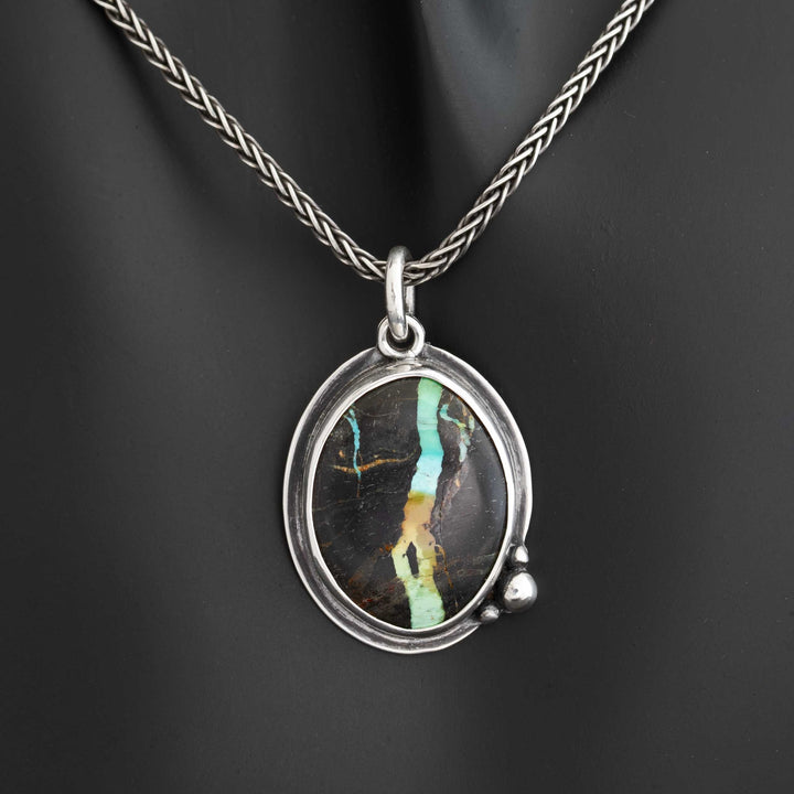 Blackjack turquoise statement necklace on dark display bust, sterling silver wheat chain, vivid ribbon matrix stone, handcrafted in Colorado