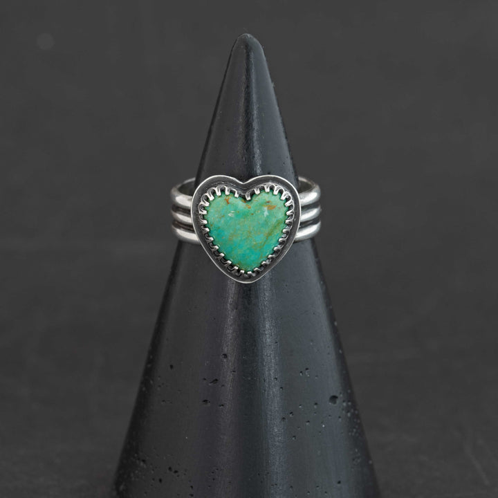 Blue-green Sonora turquoise heart ring with rust matrix flecks in serrated sterling silver bezel, size 7