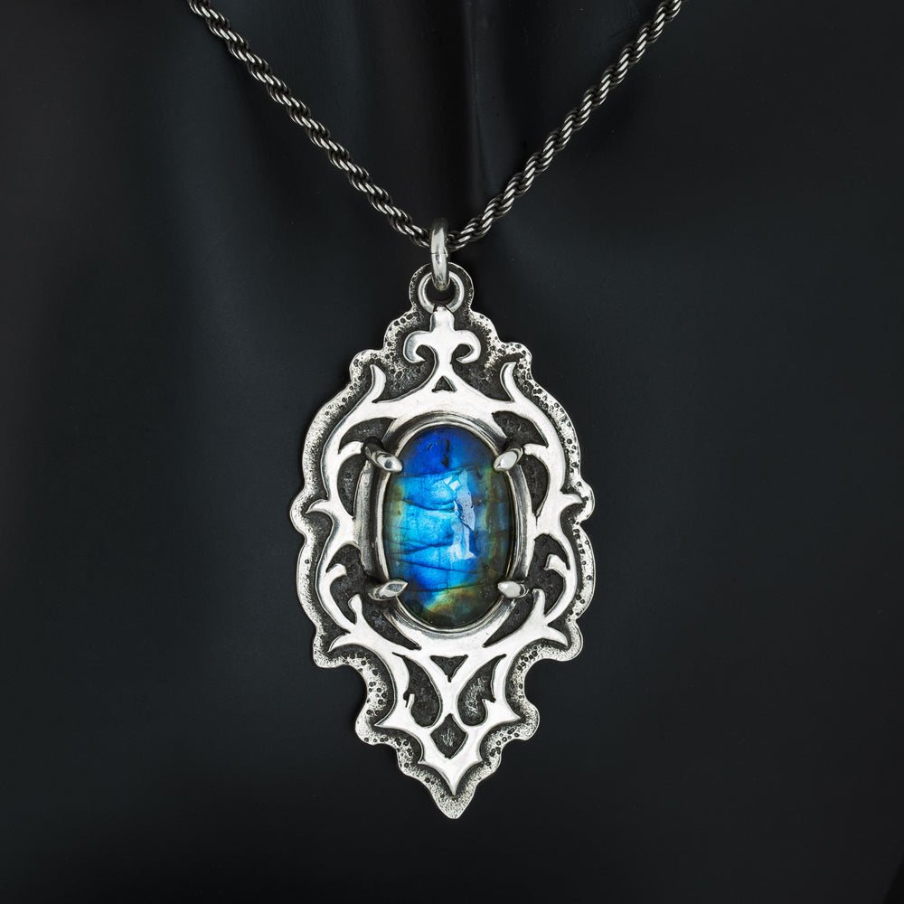 Blue labradorite gothic pendant necklace with ornate sterling silver frame on black background