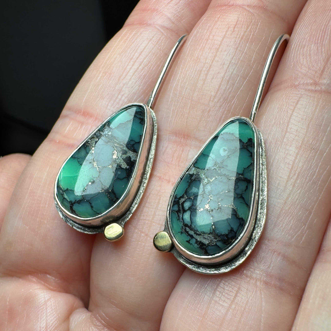 Custom earrings in sterling silver and 18K gold featuring green tear-drop shaped Emerald Rose variscite stones and gold accents.