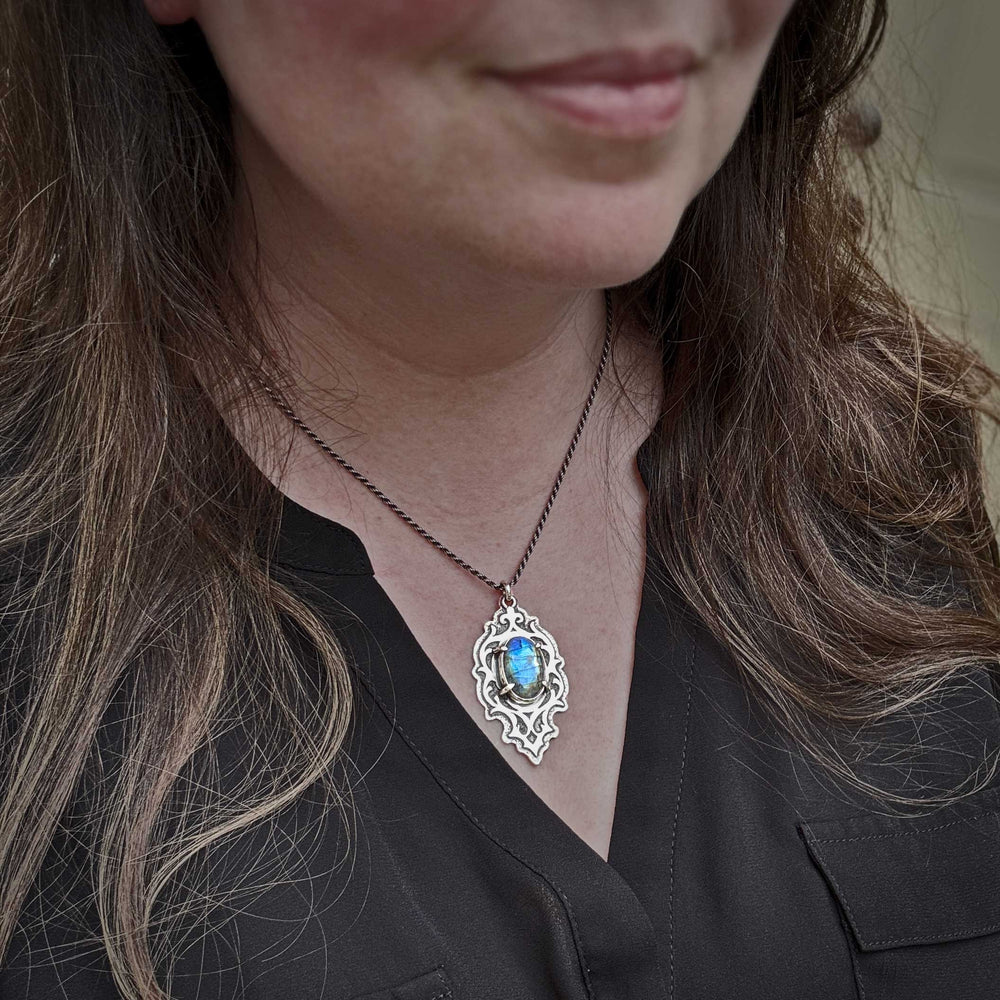 Gothic style labradorite pendant worn on model with oxidized sterling silver chain