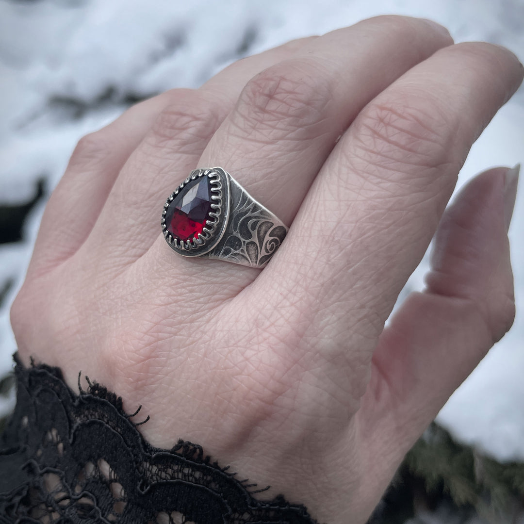 Gothic rose vampire ring featuring a deep red garnet gemstone. Handmade ring in Fort Collins, Colorado.