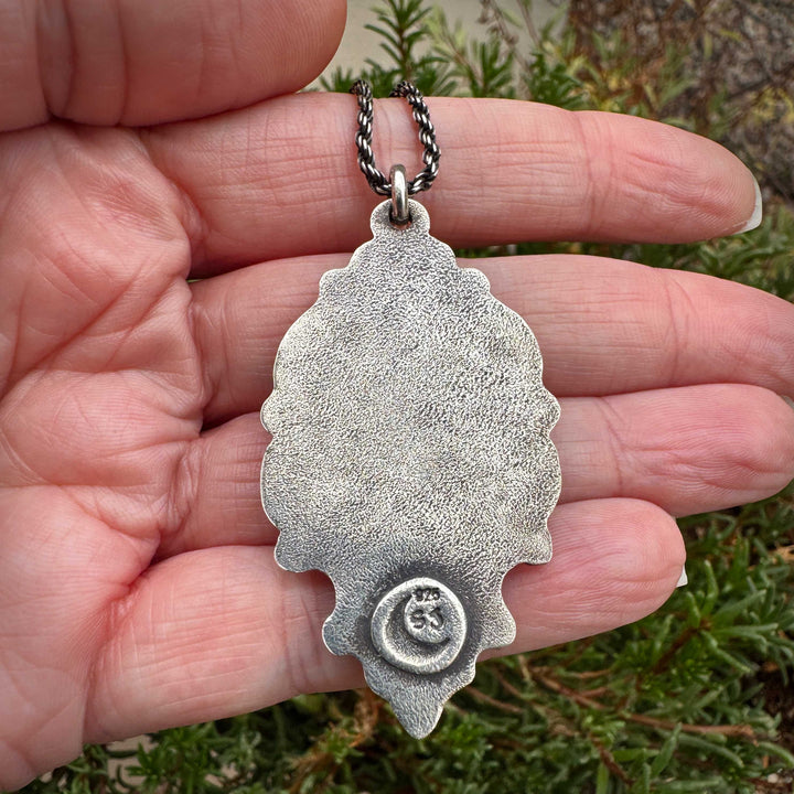 Back view of sterling silver pendant showing hallmark and craftsmanship details