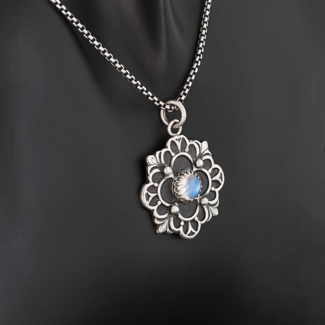 Artisan crafted sterling silver flower pendant with bezel-set June birthstone moonstone