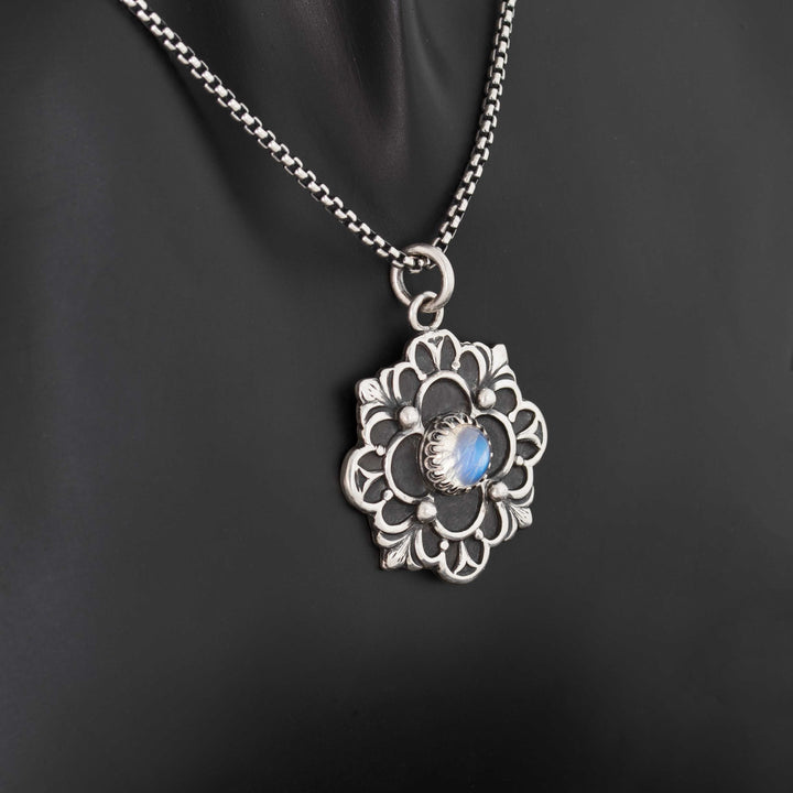 Artisan crafted sterling silver flower pendant with bezel-set June birthstone moonstone