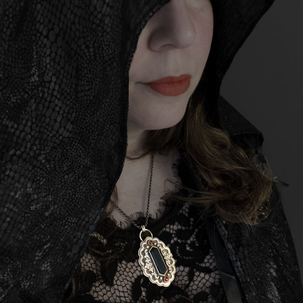 Gothic vampire statement necklace worn on the body, showing scale, weight, and ceremonial presence at the center of the chest