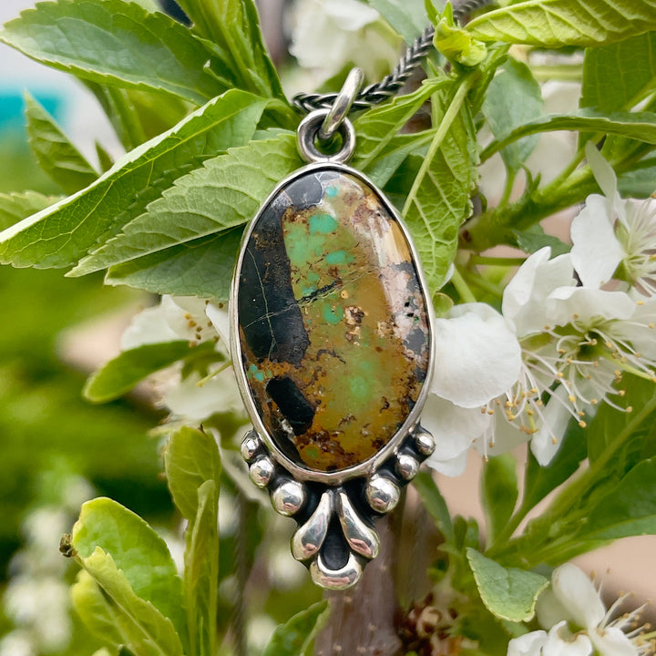 Artisan sterling silver turquoise pendant with fine silver floral accents, handmade in Colorado. 