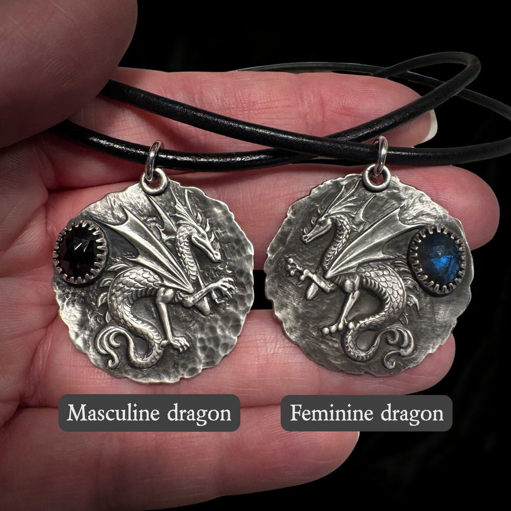 Masculine and feminine sterling silver dragon talisman designs shown side by side