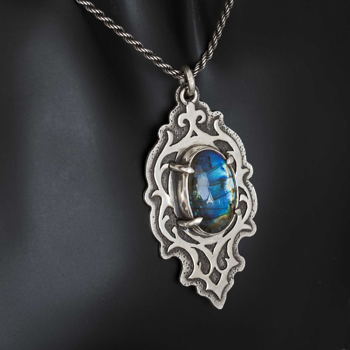 Labradorite statement pendant showing electric blue flash and intricate silver cut-work details