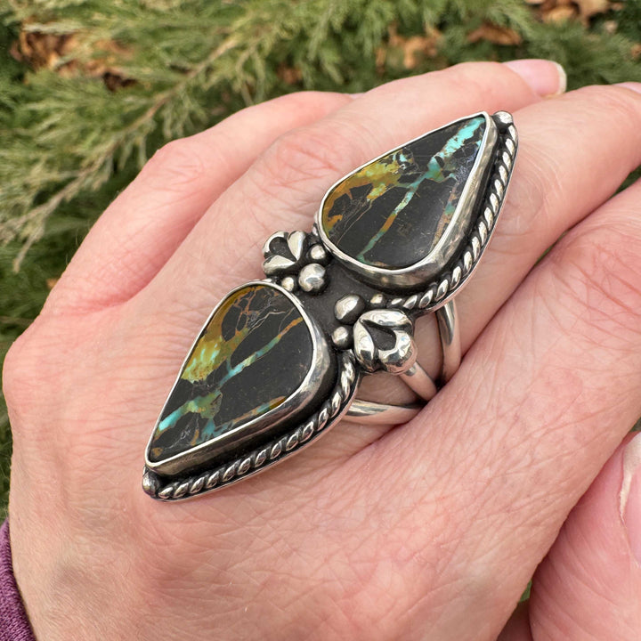 Large vertical turquoise ring shown on hand