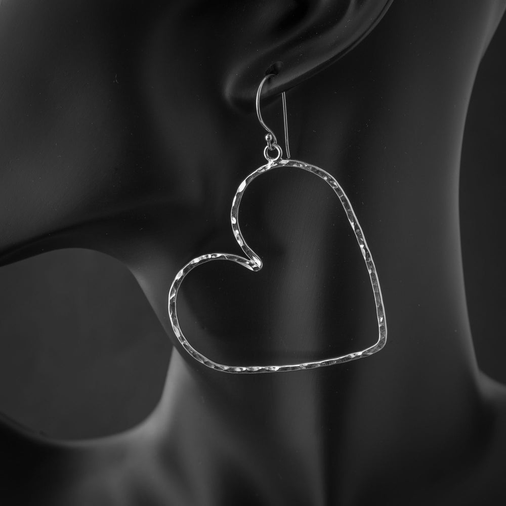 Large sterling silver heart hoop earrings with lightweight open heart design on mannequin