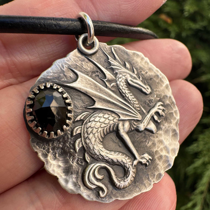 Close-up of antiqued sterling silver dragon pendant with black spinel gemstone