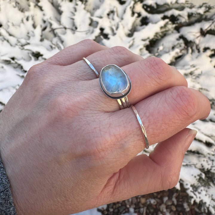 Rose cut rainbow moonstone bezel ring size 7.5 stacked with hammered bands, blue and orange flash, close up