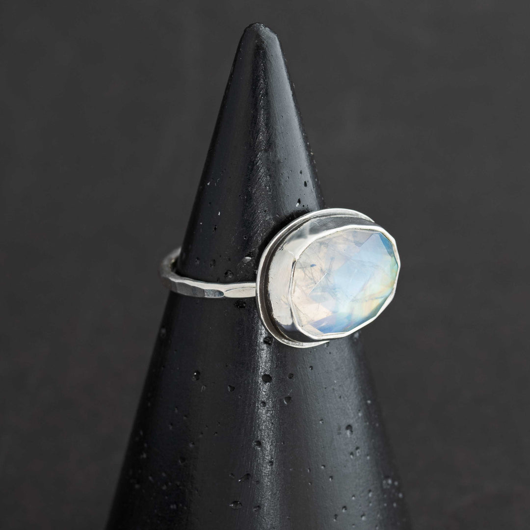 Handmade rose cut rainbow moonstone ring size 7.5 in sterling silver bezel, side view showing hammered band