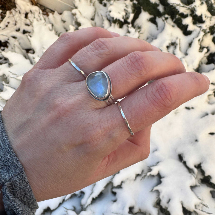 Handmade rose cut rainbow moonstone ring worn on hand outdoors, sterling silver stacker rings