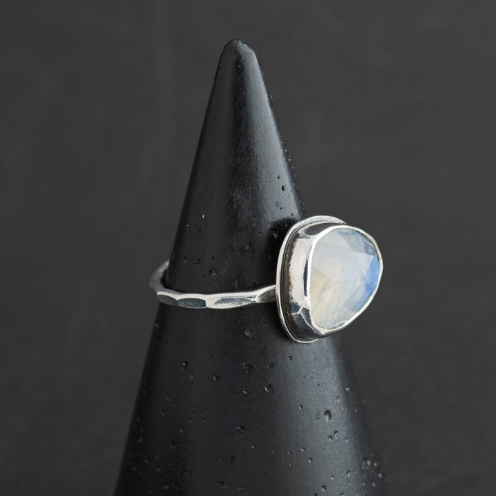 Handmade rose cut rainbow moonstone ring in sterling silver bezel, side view showing hammered band