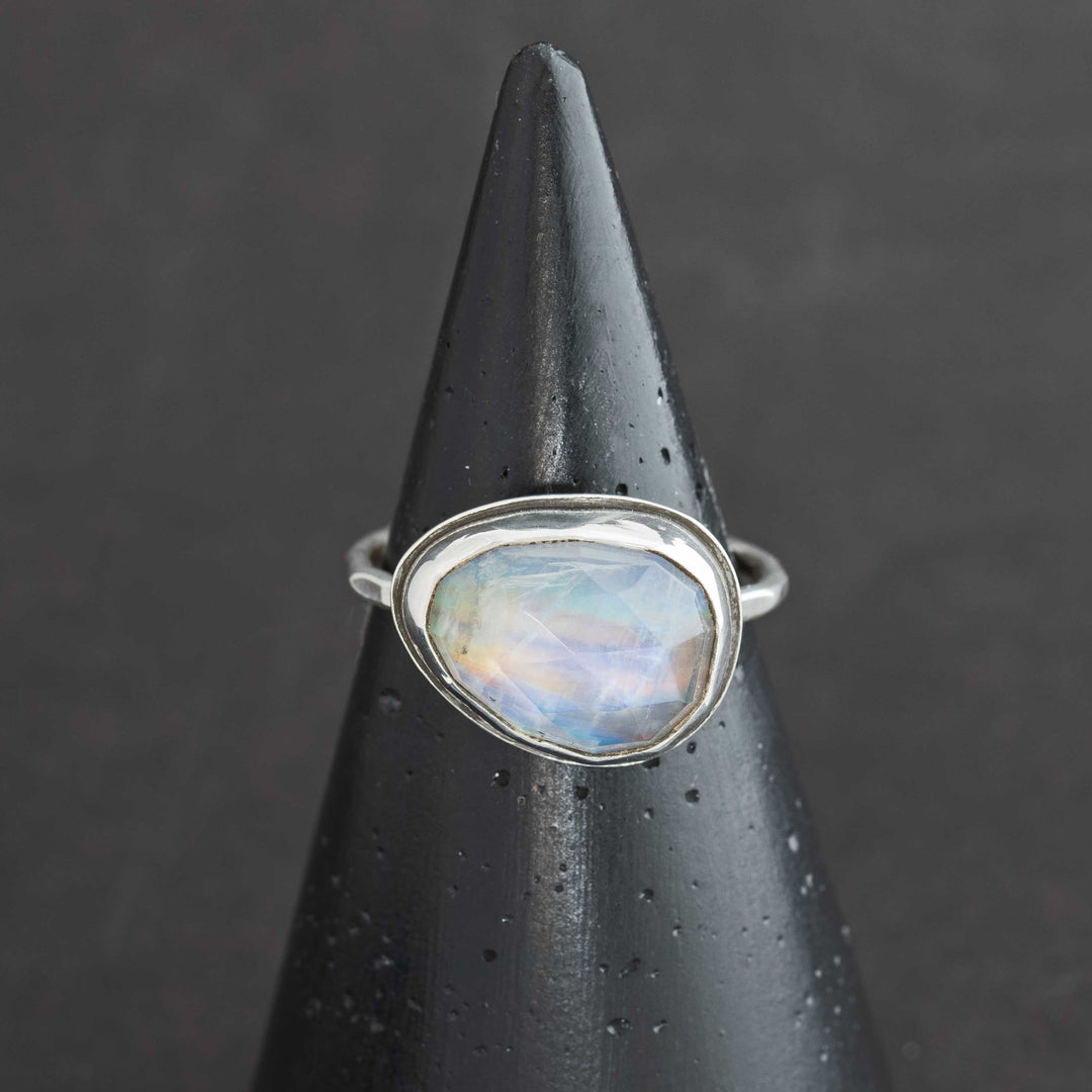 Handmade rose cut rainbow moonstone ring size 9.5 in sterling silver bezel, front view on cone display