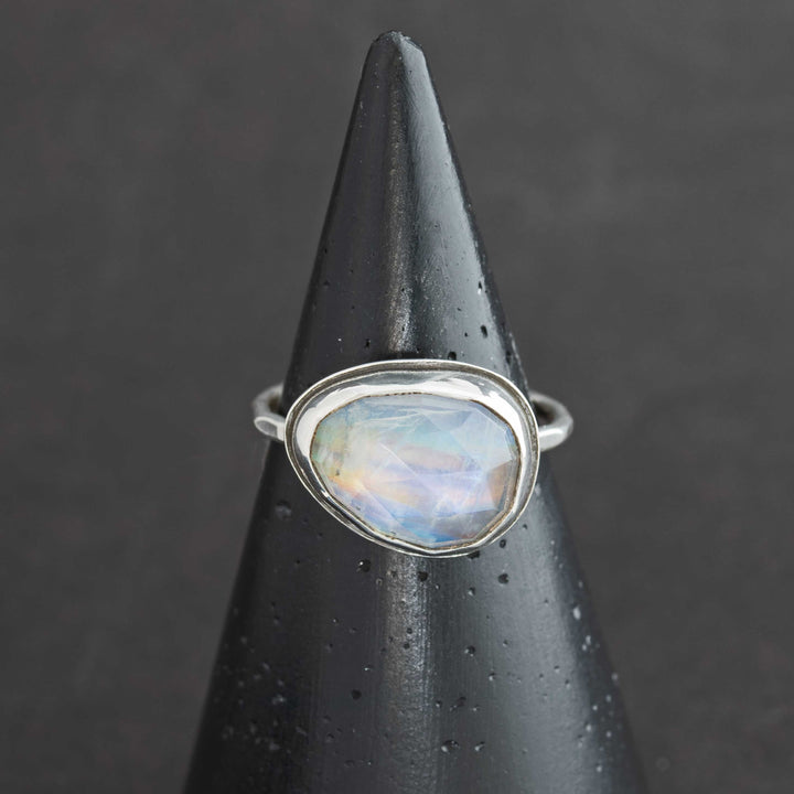 Handmade rose cut rainbow moonstone ring size 9.5 in sterling silver bezel, front view on cone display