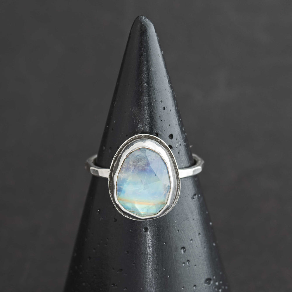Handmade rose cut rainbow moonstone ring size 9 in sterling silver bezel, front view on cone display