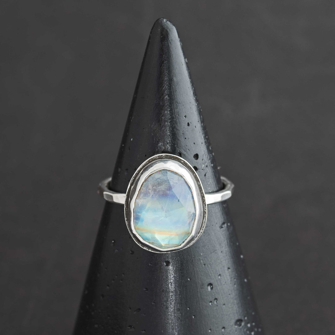 Handmade rose cut rainbow moonstone ring size 9 in sterling silver bezel, front view on cone display