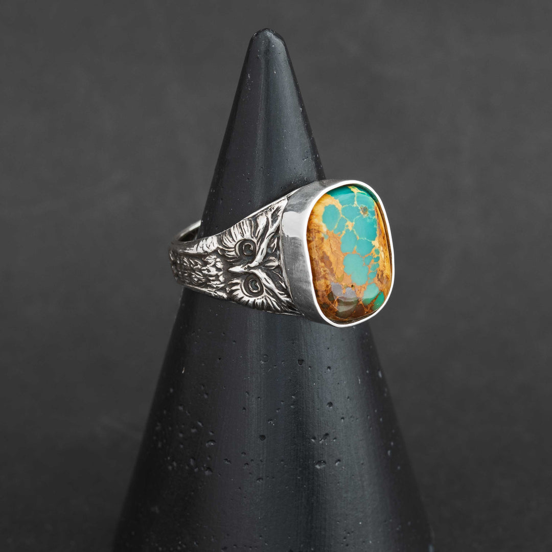 Side view of Royston Ribbon turquoise owl ring by Silverthaw Jewelry, featuring detailed owl engraving and bezel-set turquoise cabochon.