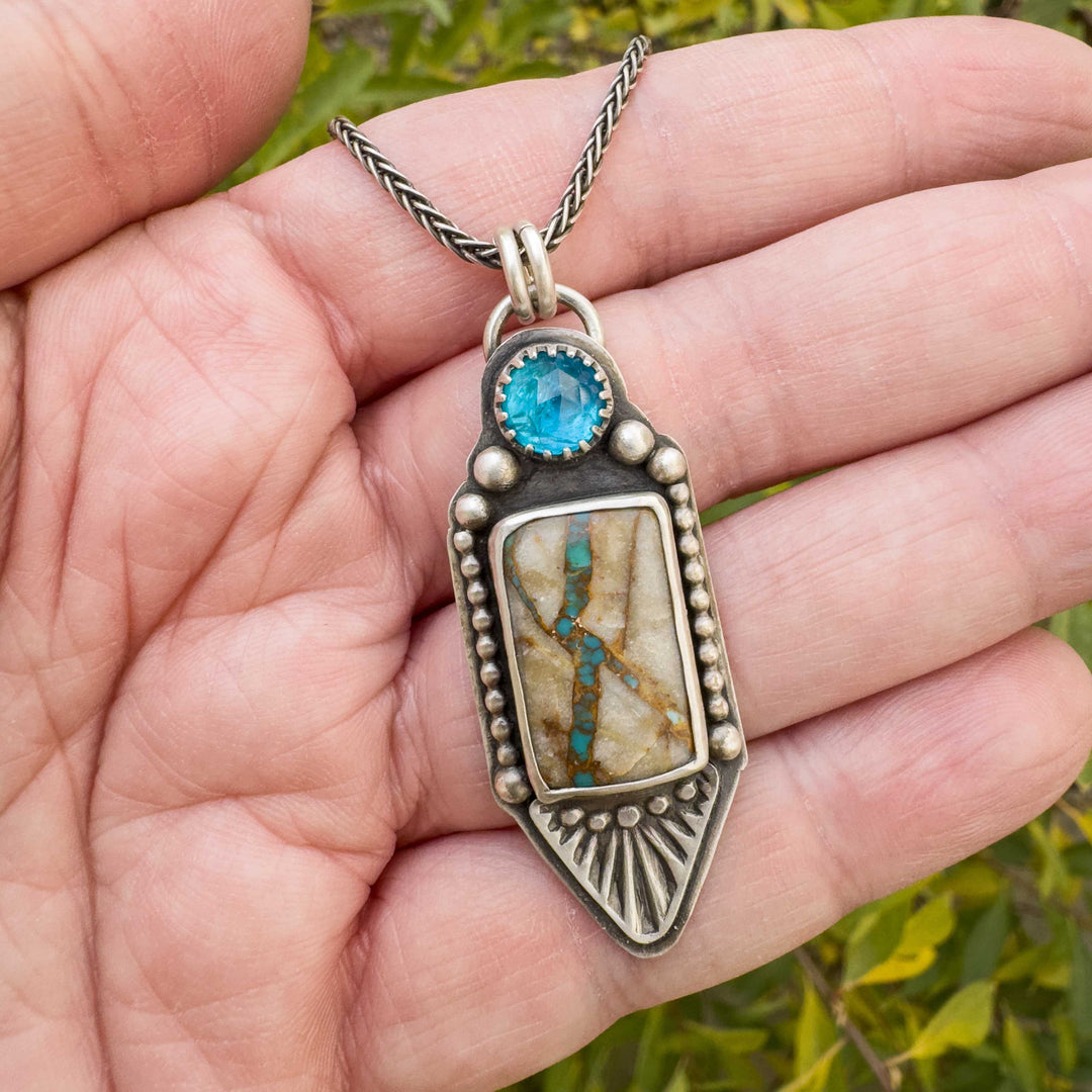 Royston Ribbon turquoise and apatite sterling silver pendant shown in hand to display size and stone detail.